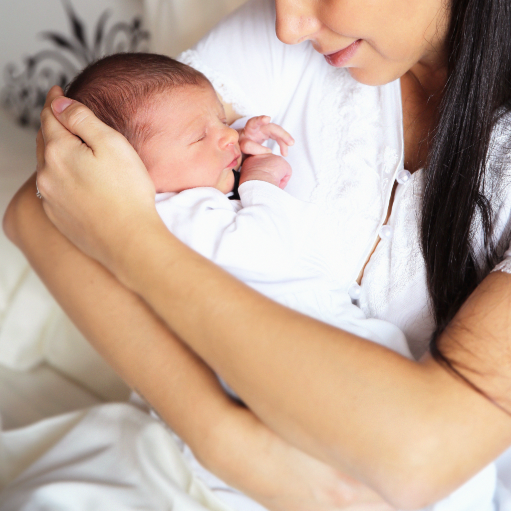 woman holding newborn child