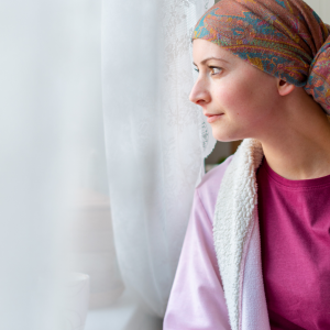 woman with pretty headscarf looking out of window