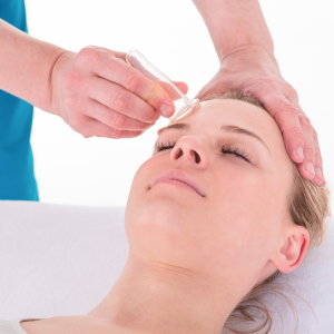 woman receiving facial cupping treatment